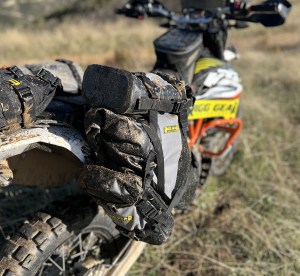 Photo showing Hurricane Dual Sport saddlebags installed on KTM 690 after going through muddy puddles